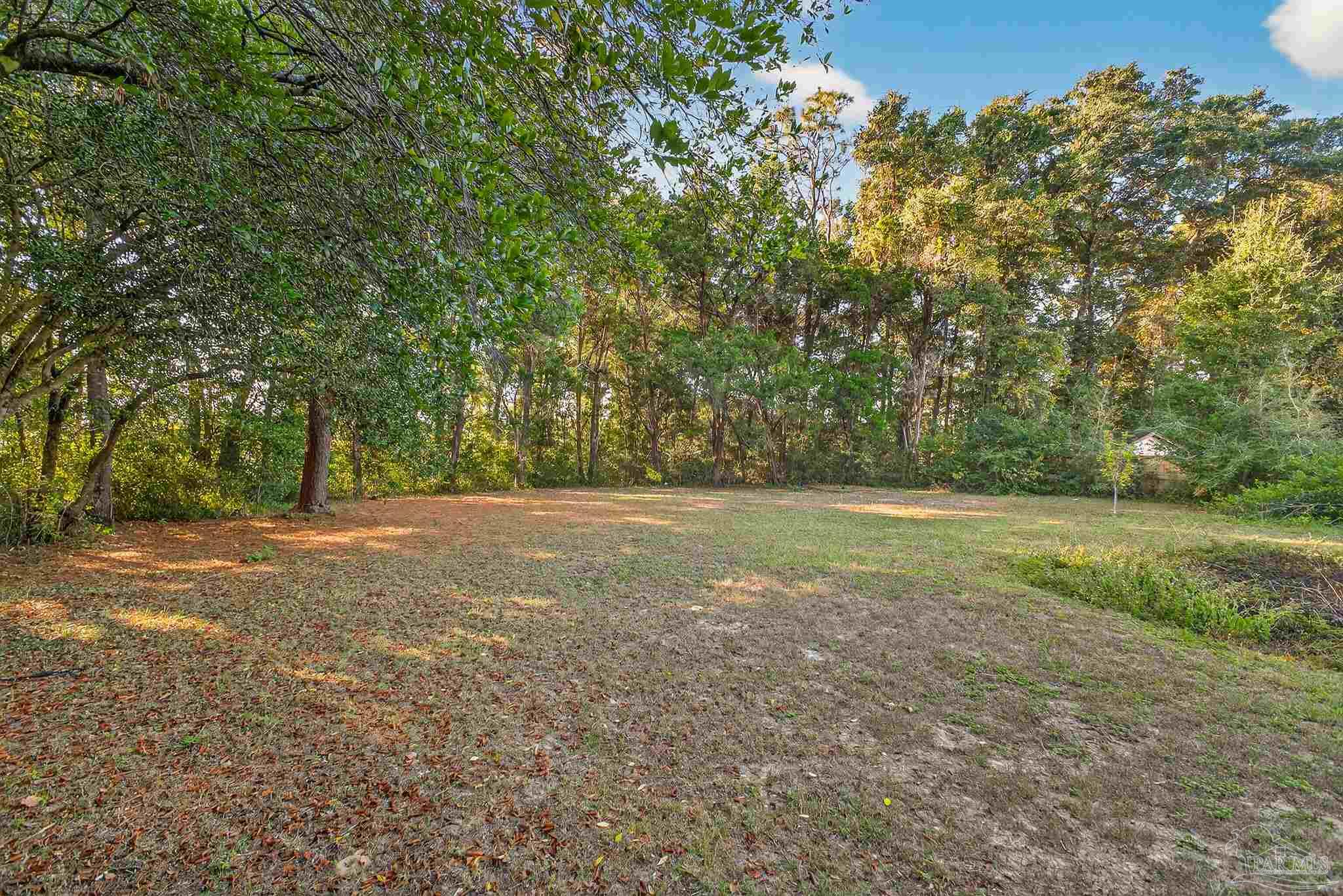 6571 Cedar Street Milton, FL 32570 - Photo 45 of 47 a view of a field with trees in the background