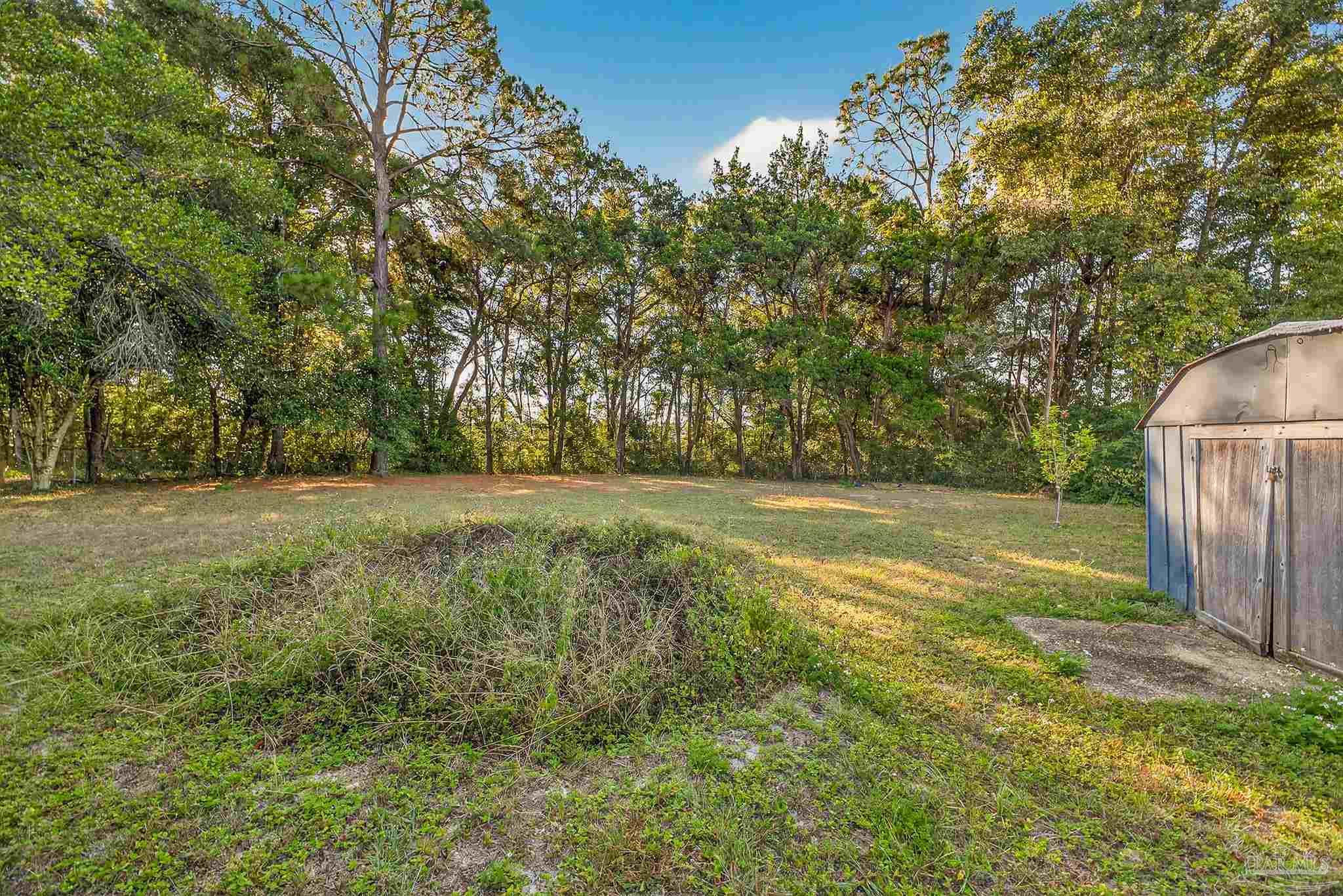 6571 Cedar Street Milton, FL 32570 - Photo 46 of 47 a view of outdoor space with deck and yard