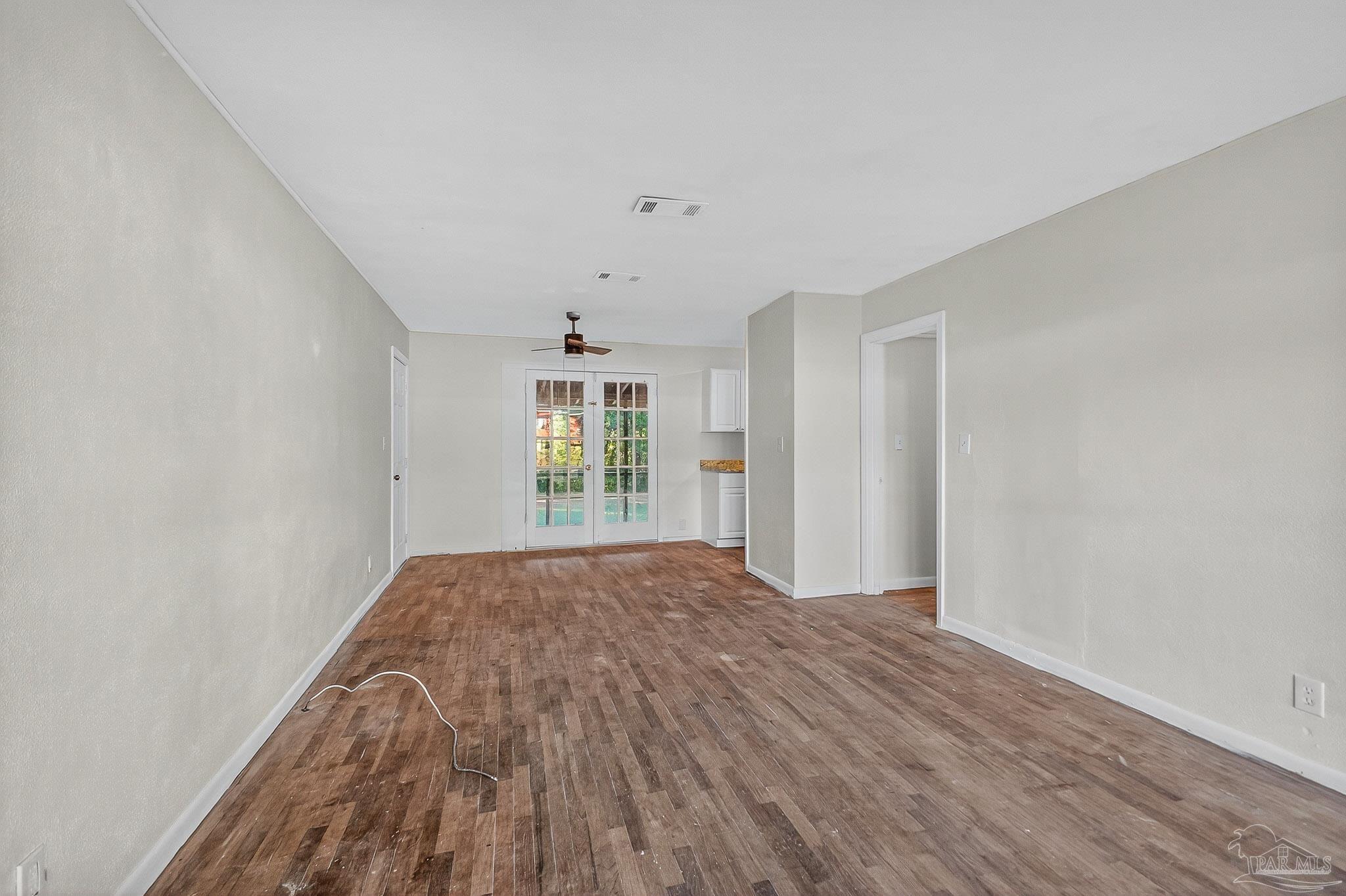 6571 Cedar Street Milton, FL 32570 - Photo 6 of 47 wooden floor in an empty room with a window