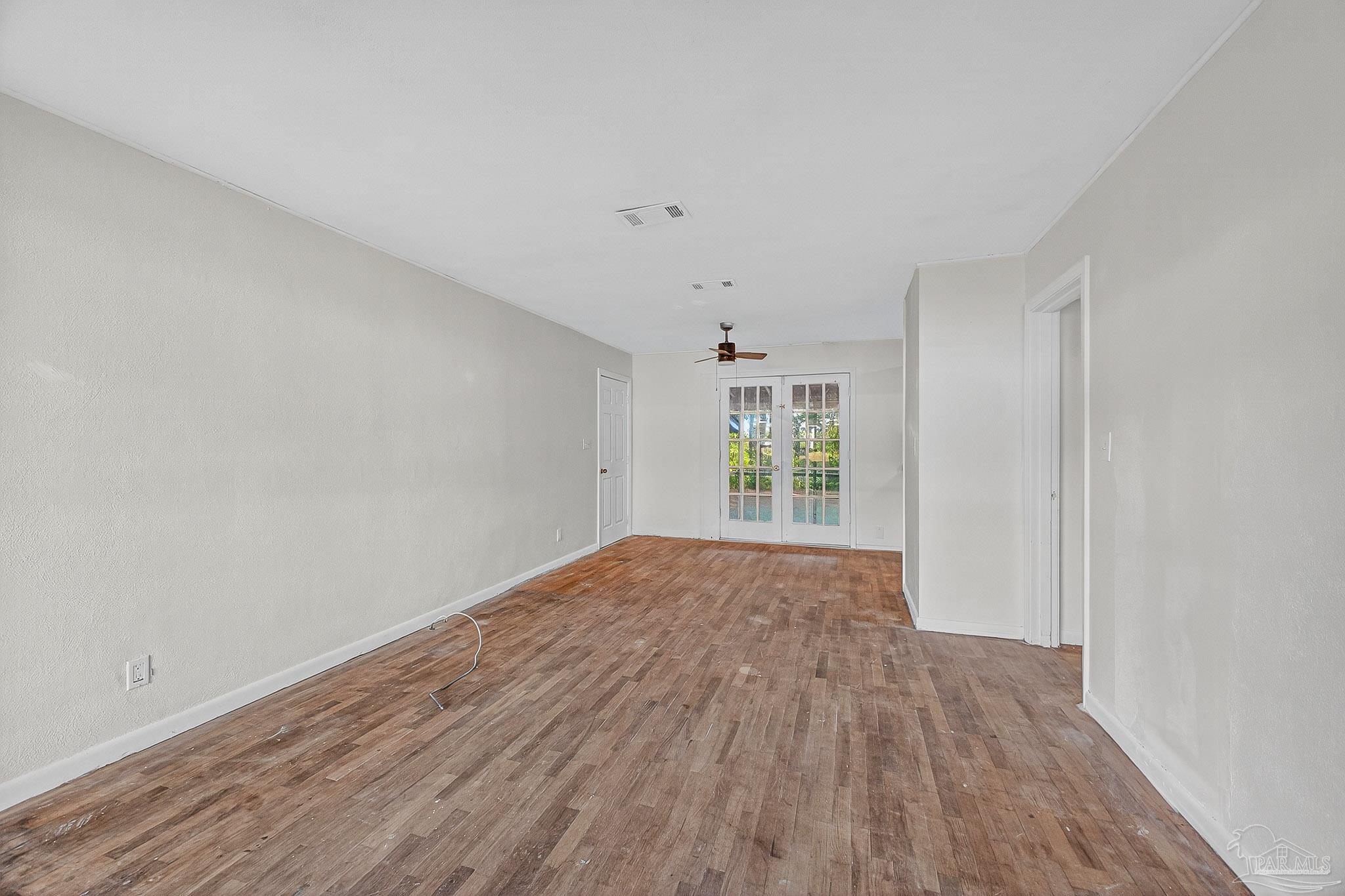 6571 Cedar Street Milton, FL 32570 - Photo 7 of 47 a view of empty room with wooden floor and fan