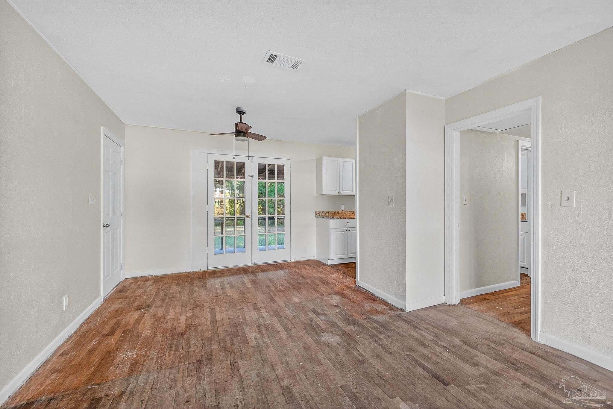 6571 Cedar Street Milton, FL 32570 - Photo 10 of 47 a view of an empty room with wooden floor and a window
