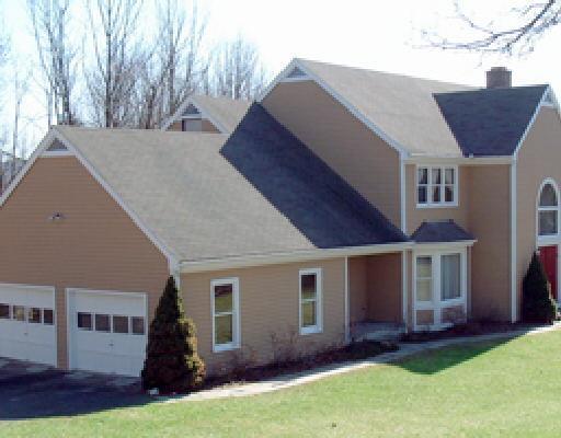 a front view of house with yard and green space