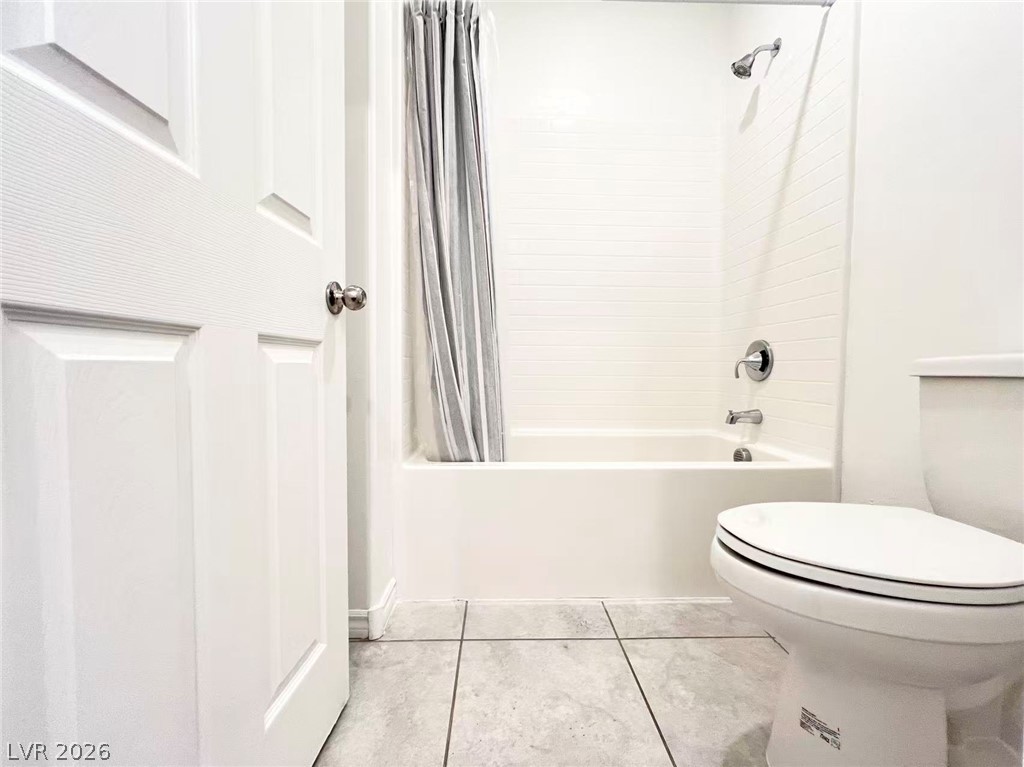 925 Bayberry Ridge Street Henderson, NV 89052 - Photo 21 of 27 A well-maintained bathroom with a white tub and clean tile flooring awaits.