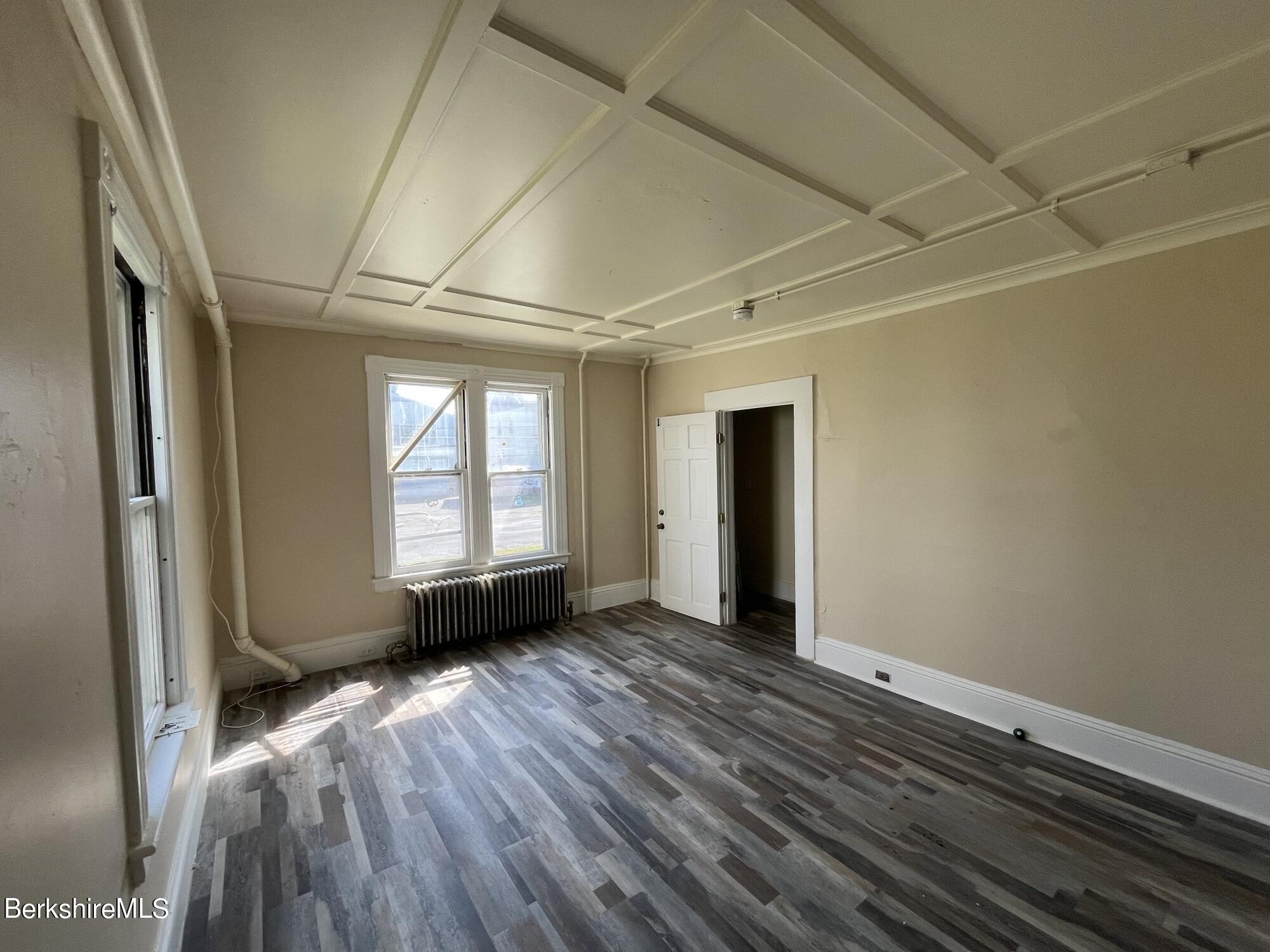 21 Blackinton Street, Unit 1 North Adams, MA 01247 - Photo 2 of 13 an empty room with wooden floor and windows