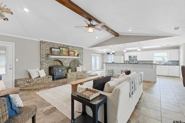 a living room with furniture a fireplace and a table