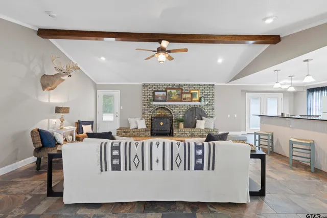 a living room with furniture a fireplace and a chandelier