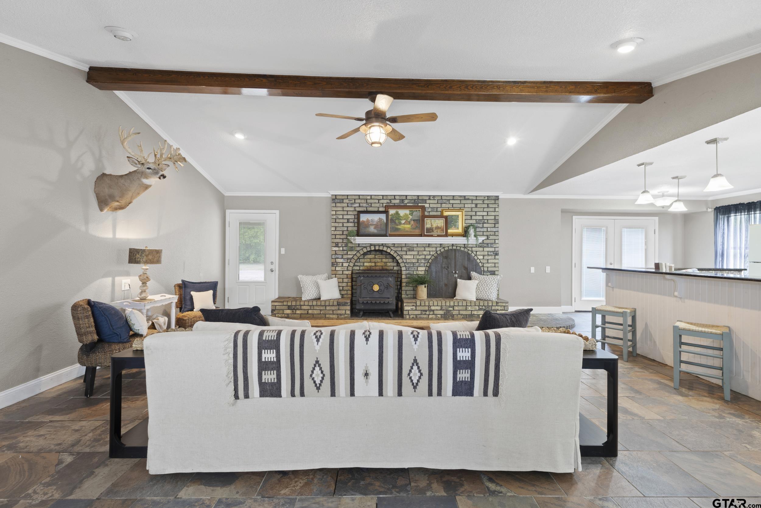 38 Quail Valley Road Mount Vernon, TX 75457 - Photo 14 of 46 a living room with furniture a fireplace and a chandelier