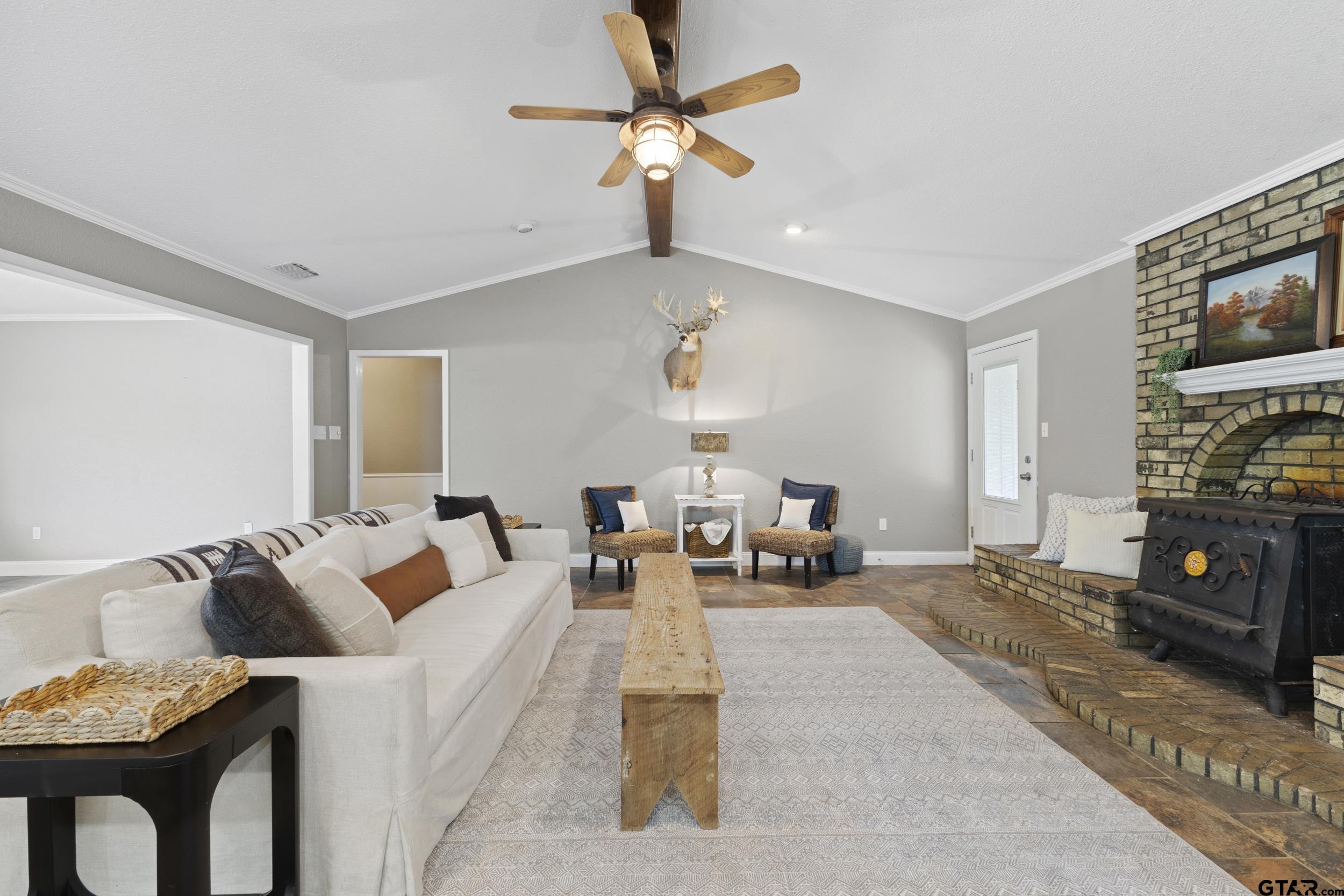 38 Quail Valley Road Mount Vernon, TX 75457 - Photo 15 of 46 a living room with furniture a flat screen tv and a fireplace