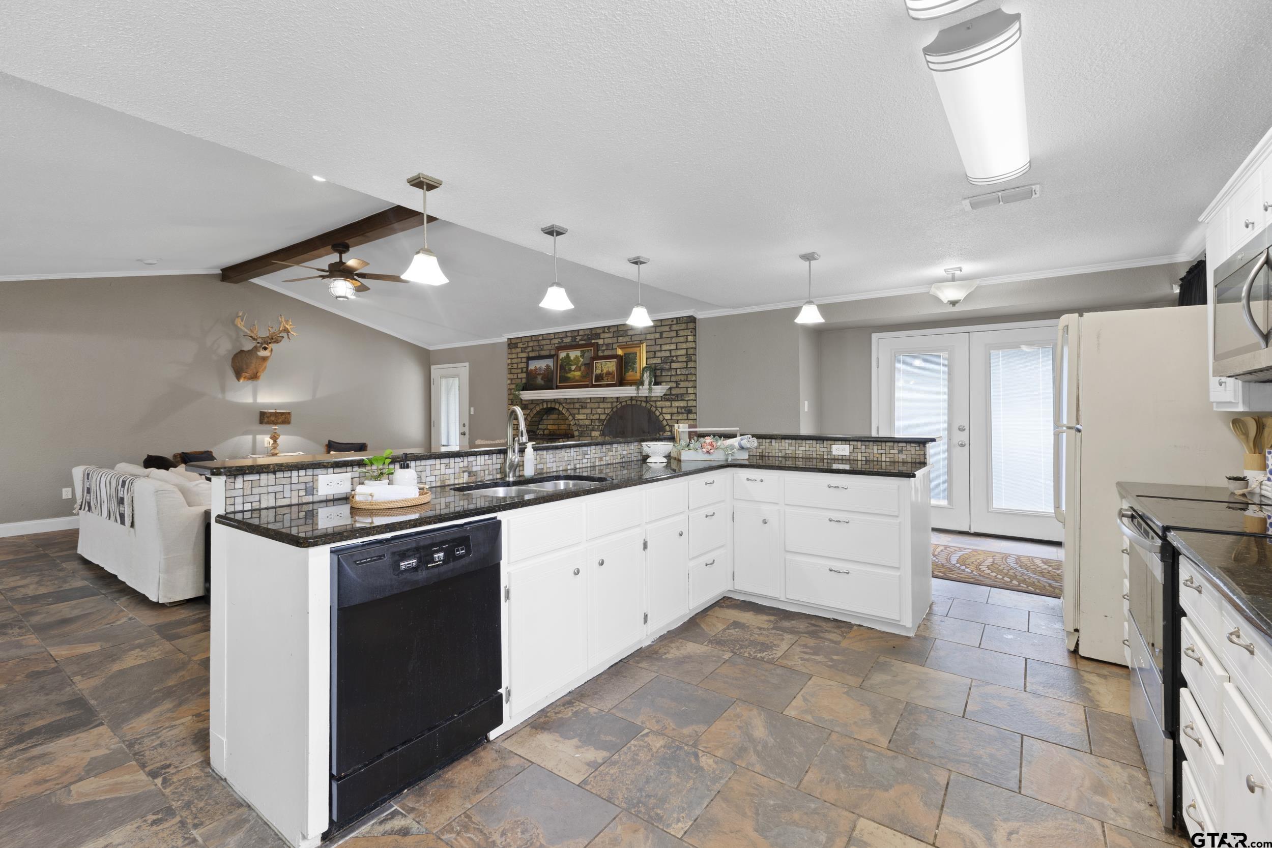 38 Quail Valley Road Mount Vernon, TX 75457 - Photo 18 of 46 a large kitchen with stainless steel appliances granite countertop a stove and a sink