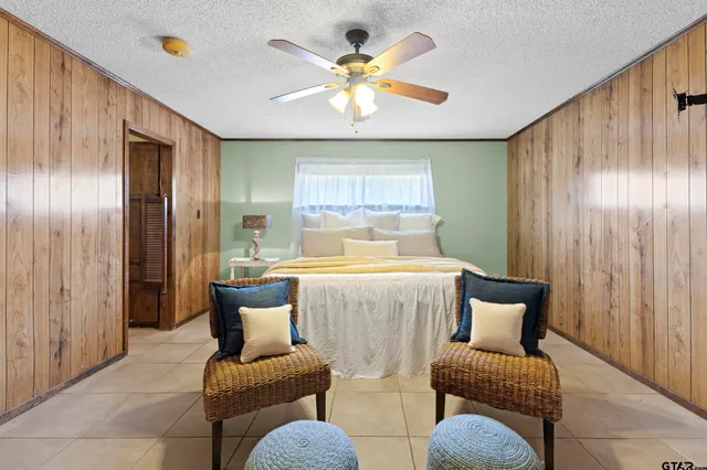 a living room with furniture and chandelier