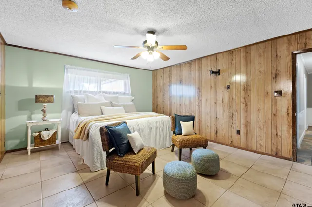 a bedroom with a bed and chandelier
