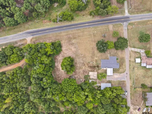 an aerial view of a house with a yard basket ball court and outdoor seating