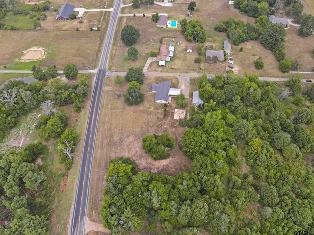 an aerial view of residential building with yard