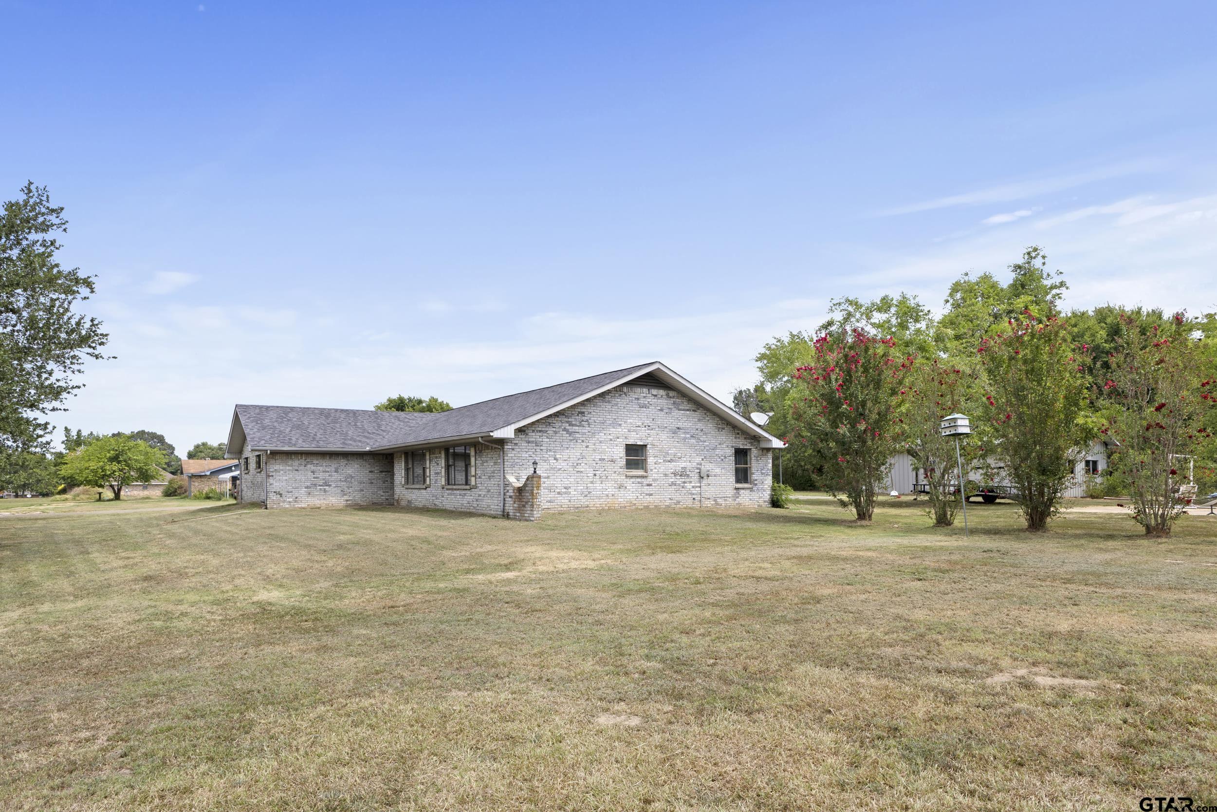 38 Quail Valley Road Mount Vernon, TX 75457 - Photo 6 of 46 a view of a house with a big yard and large trees