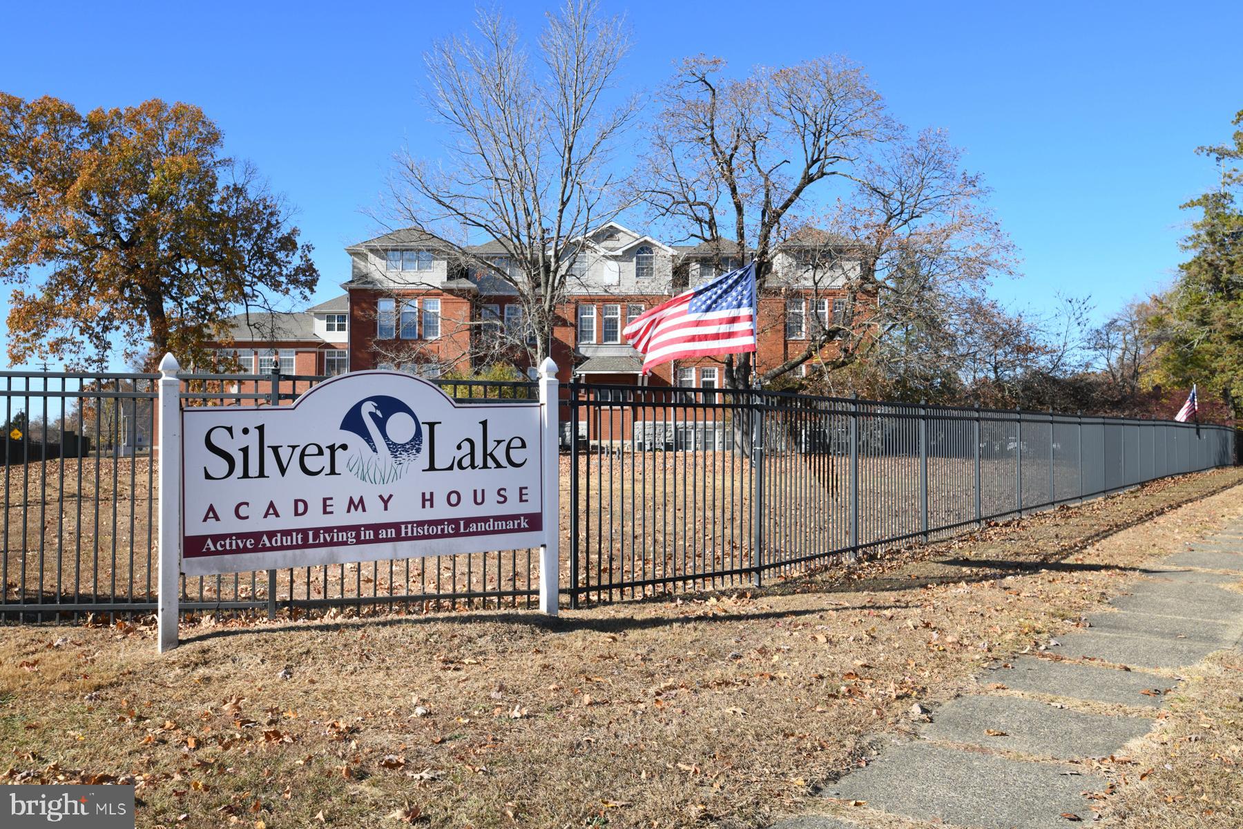 100 Aura Road, Unit 110 Clayton, NJ 08312 - Photo 2 of 21 a street sign on a sidewalk next to a road