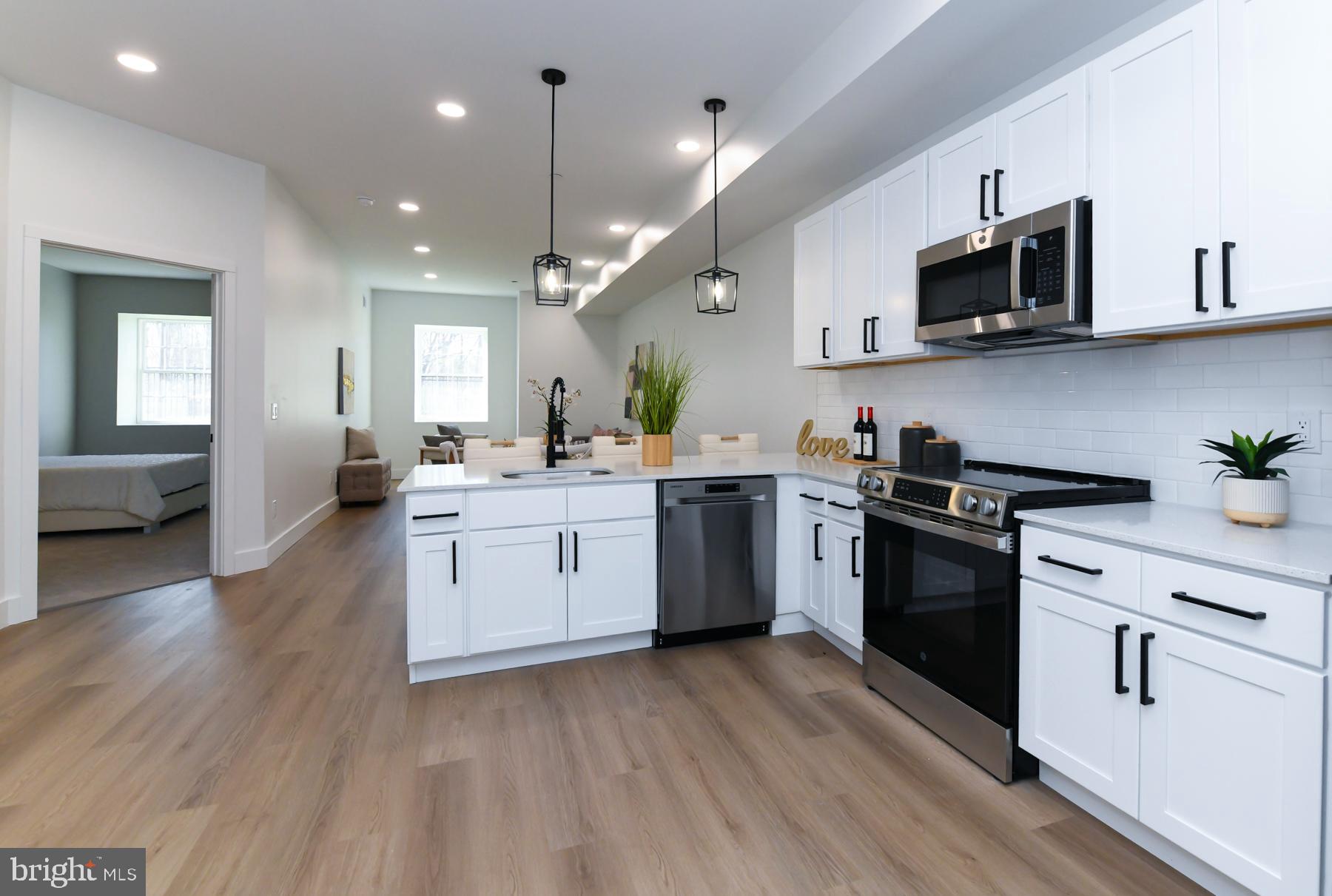 100 Aura Road, Unit 110 Clayton, NJ 08312 - Photo 4 of 21 a kitchen with a sink stainless steel appliances and cabinets