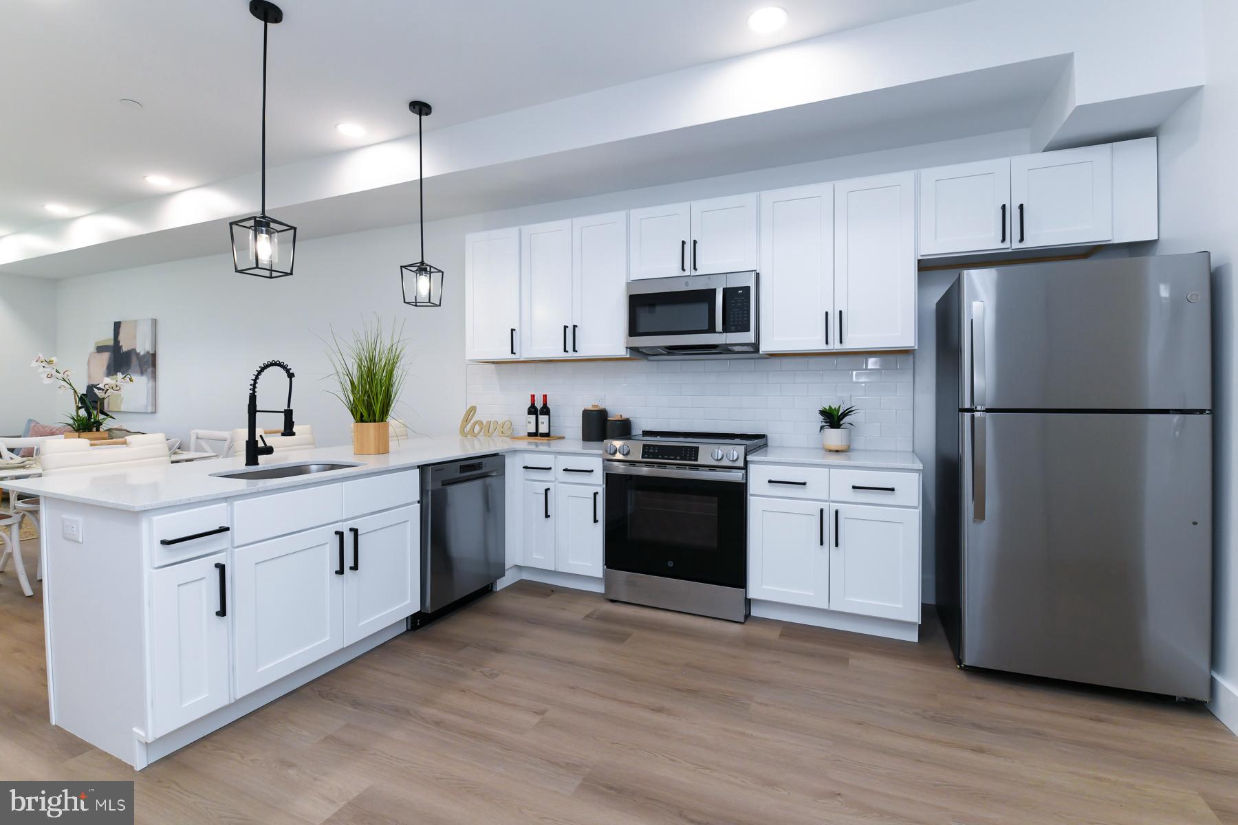 100 Aura Road, Unit 110 Clayton, NJ 08312 - Photo 5 of 21 a kitchen with stainless steel appliances a refrigerator sink and microwave