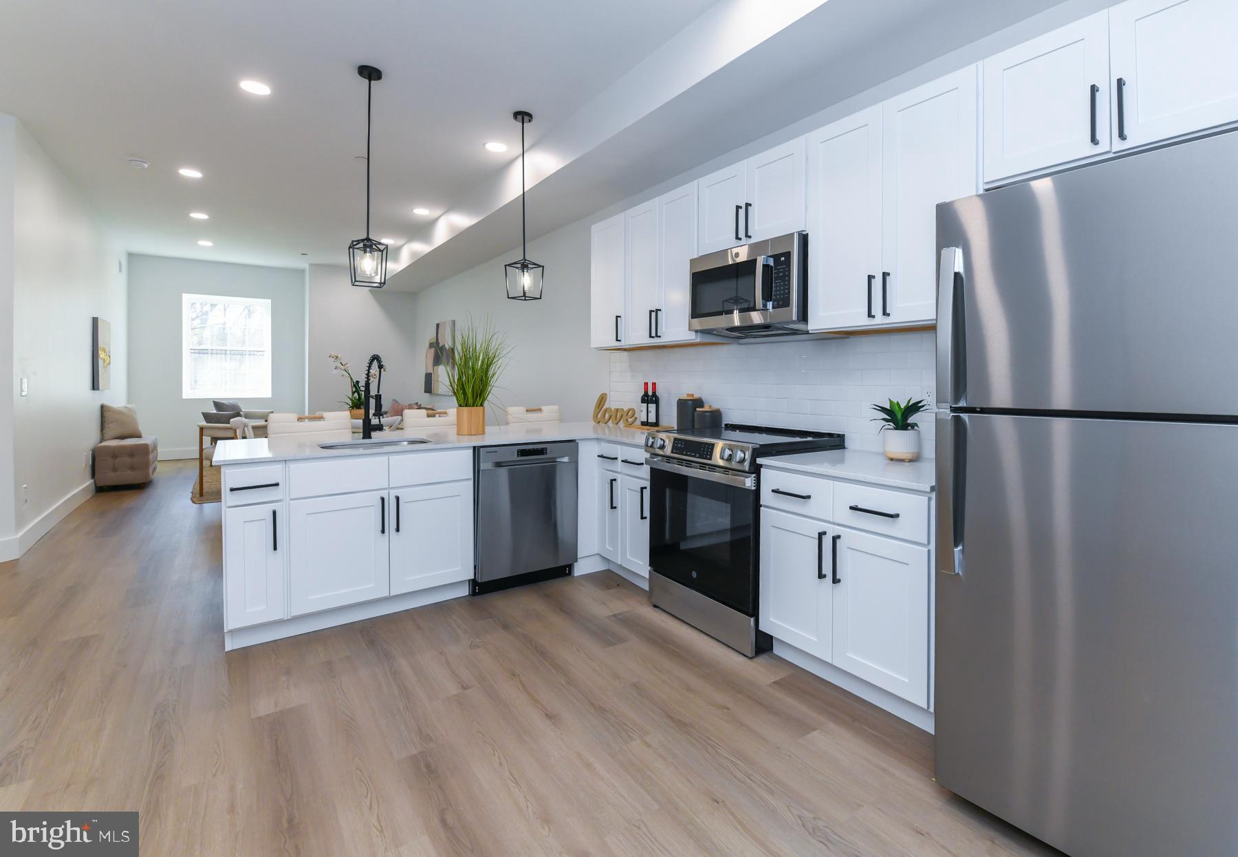 100 Aura Road, Unit 110 Clayton, NJ 08312 - Photo 6 of 21 a kitchen with white cabinets and white appliances