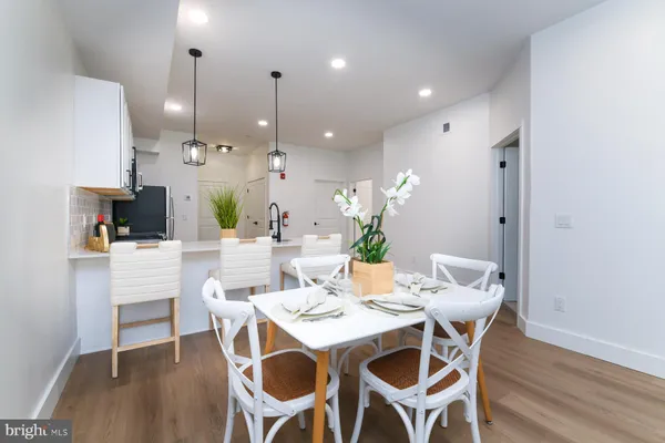 a dining room with furniture and wooden floor