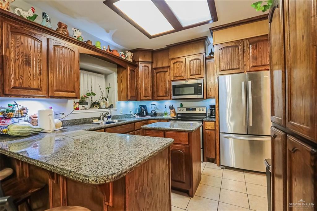 4701 Russell Circle Mission, TX 78574 - Photo 8 of 37 a kitchen with refrigerator and cabinets