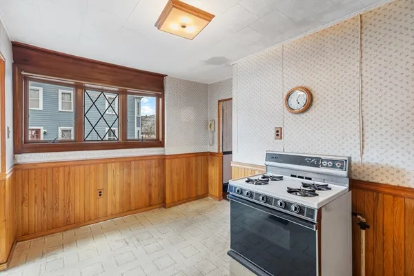a white refrigerator freezer and a stove sitting inside of a kitchen