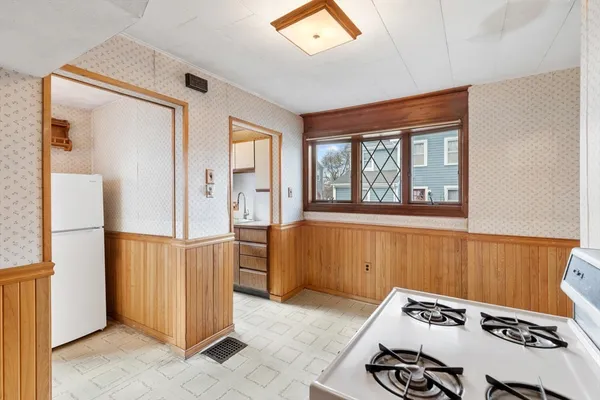 a kitchen with a sink a counter top space and a refrigerator