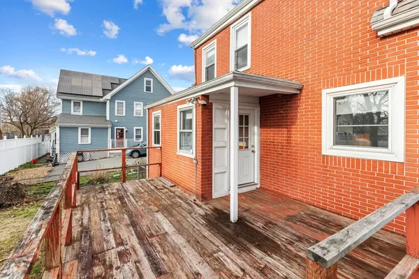 a view of a house with a wooden fence