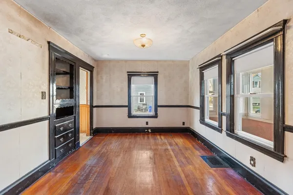 wooden floor in an empty room and a window