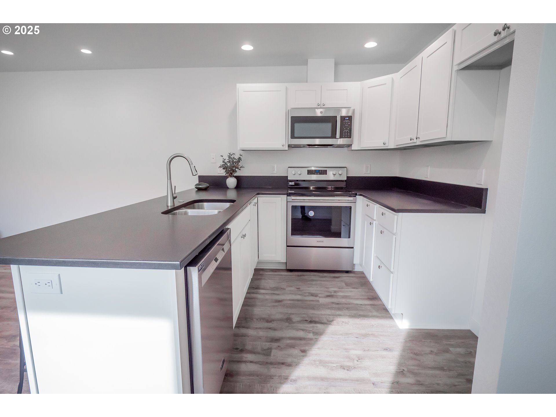 120 65th Place Springfield, OR 97478 - Photo 3 of 45 a kitchen with stainless steel appliances granite countertop a sink stove and microwave