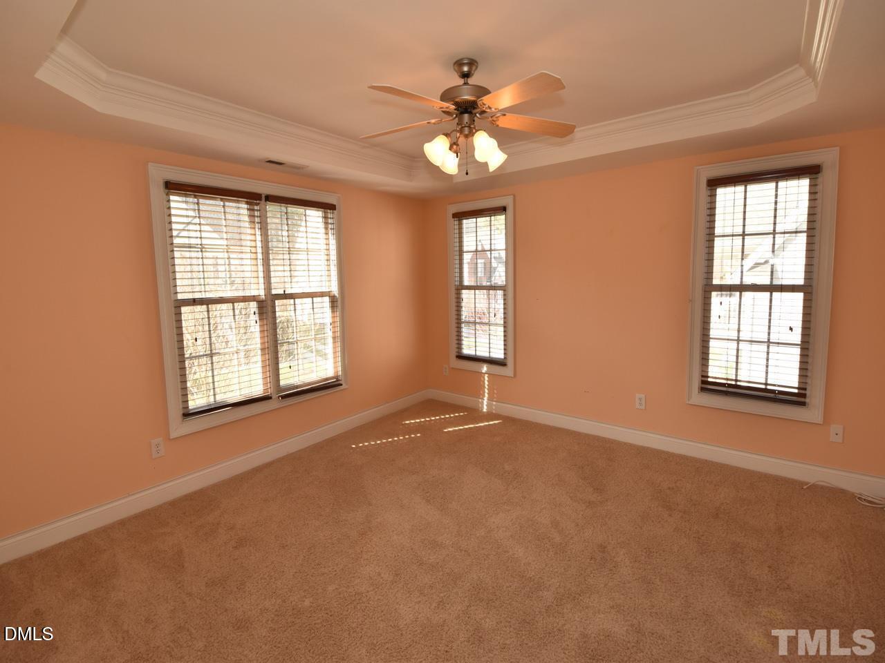 118 Fort Jackson Road Morrisville, NC 27560 - Photo 11 of 21 an empty room with windows and chandelier fan