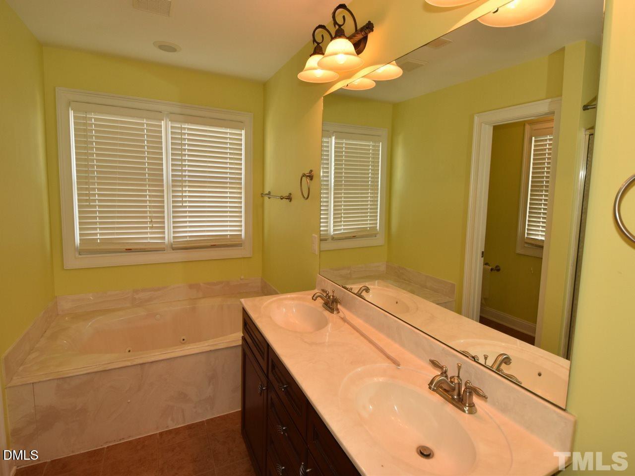 118 Fort Jackson Road Morrisville, NC 27560 - Photo 12 of 21 a bathroom with a sink a mirror and a shower