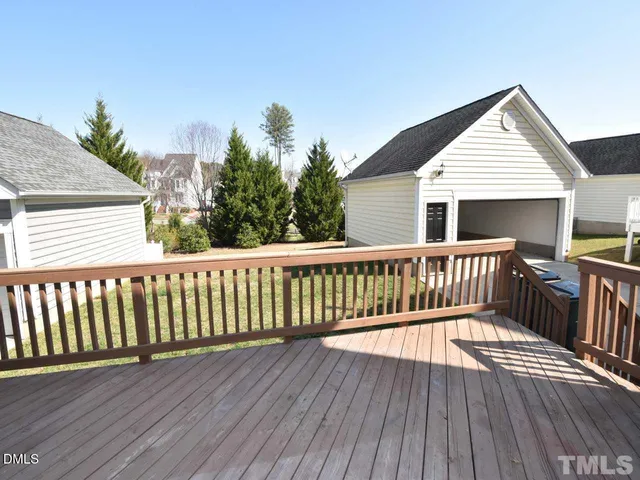 a view of a wooden deck with a yard
