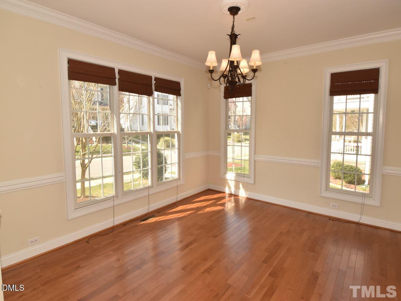 118 Fort Jackson Road Morrisville, NC 27560 - Photo 4 of 21 a view of an empty room with wooden floor and a window