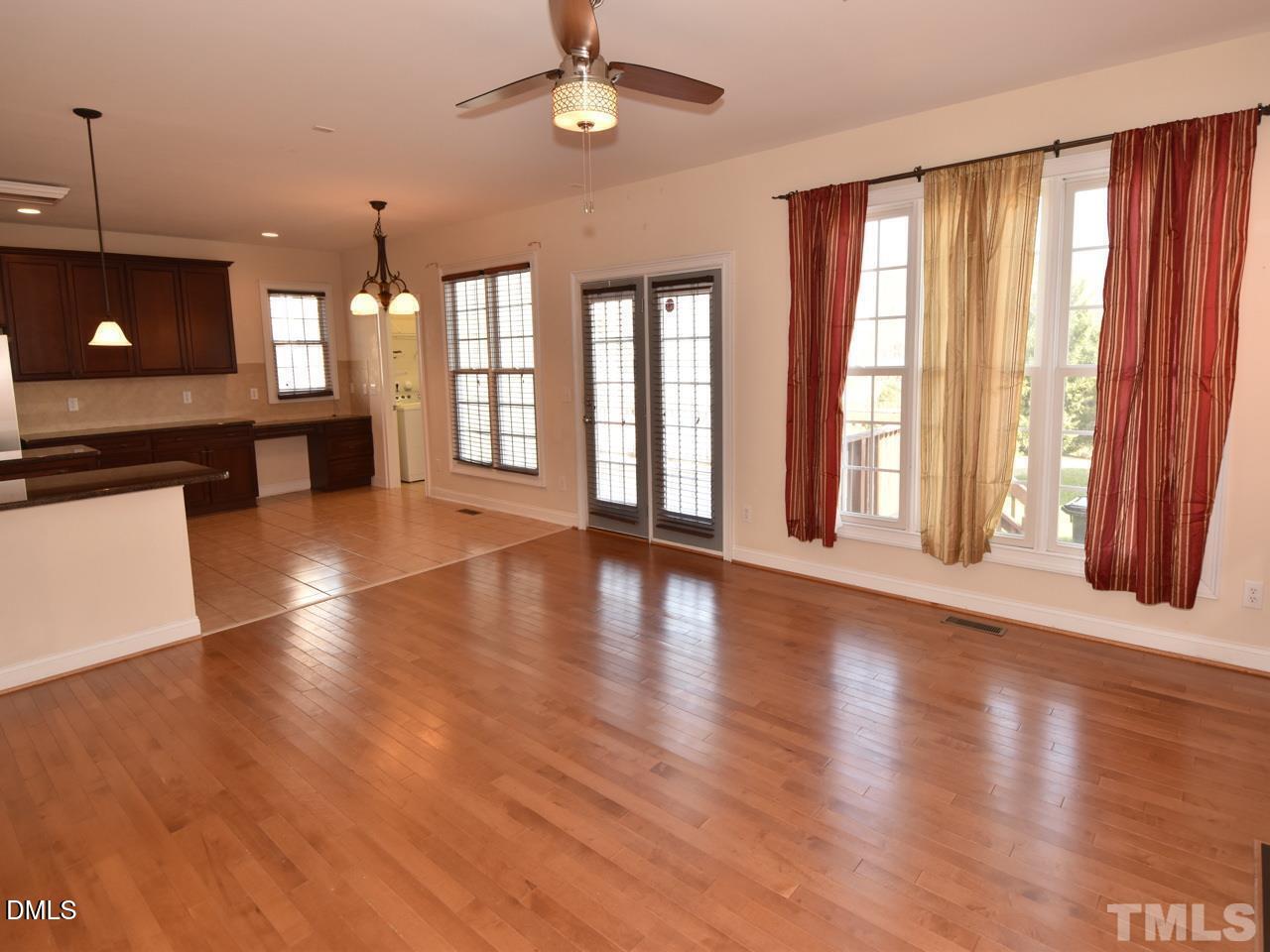 118 Fort Jackson Road Morrisville, NC 27560 - Photo 5 of 21 an empty room with wooden floor and windows