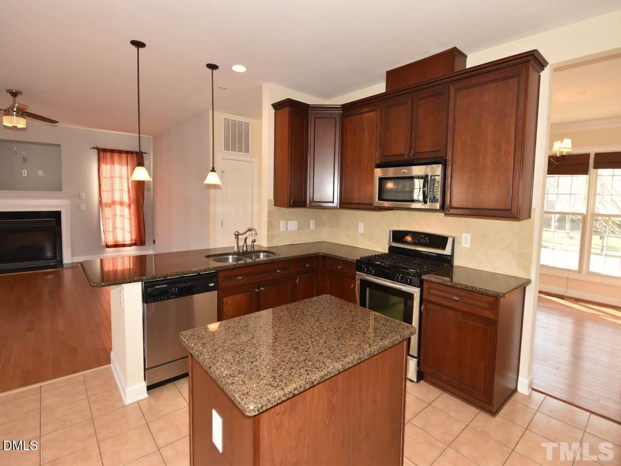 118 Fort Jackson Road Morrisville, NC 27560 - Photo 7 of 21 a kitchen with stainless steel appliances granite countertop a sink stove and refrigerator