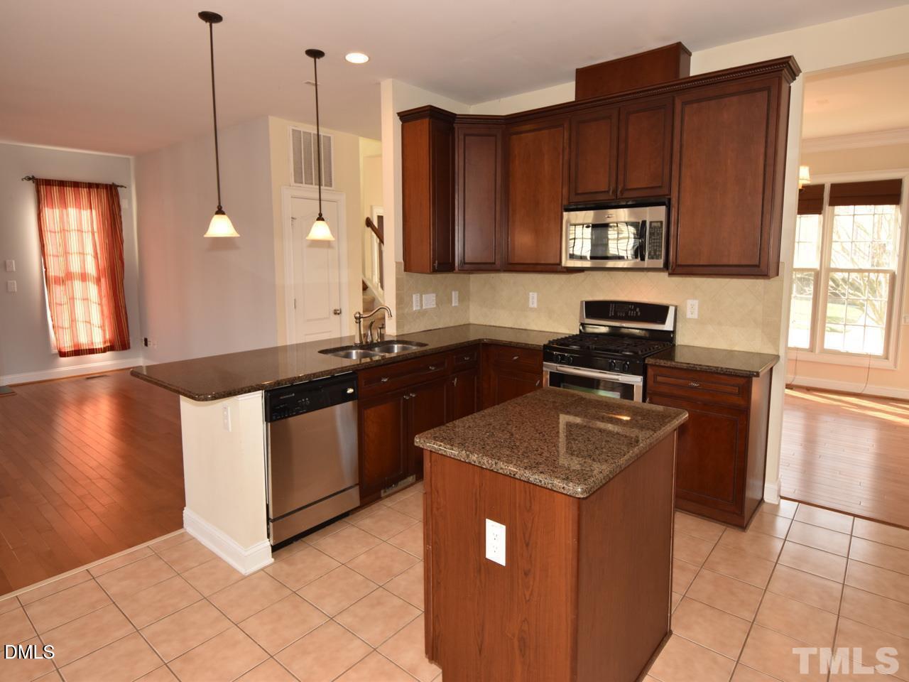 118 Fort Jackson Road Morrisville, NC 27560 - Photo 9 of 21 a kitchen with stainless steel appliances granite countertop a sink stove and refrigerator