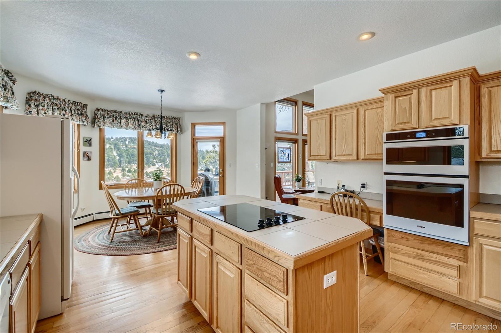 1634 Muirfield Lane Evergreen, CO 80439 - Photo 11 of 40 a kitchen with a stove a sink and a refrigerator