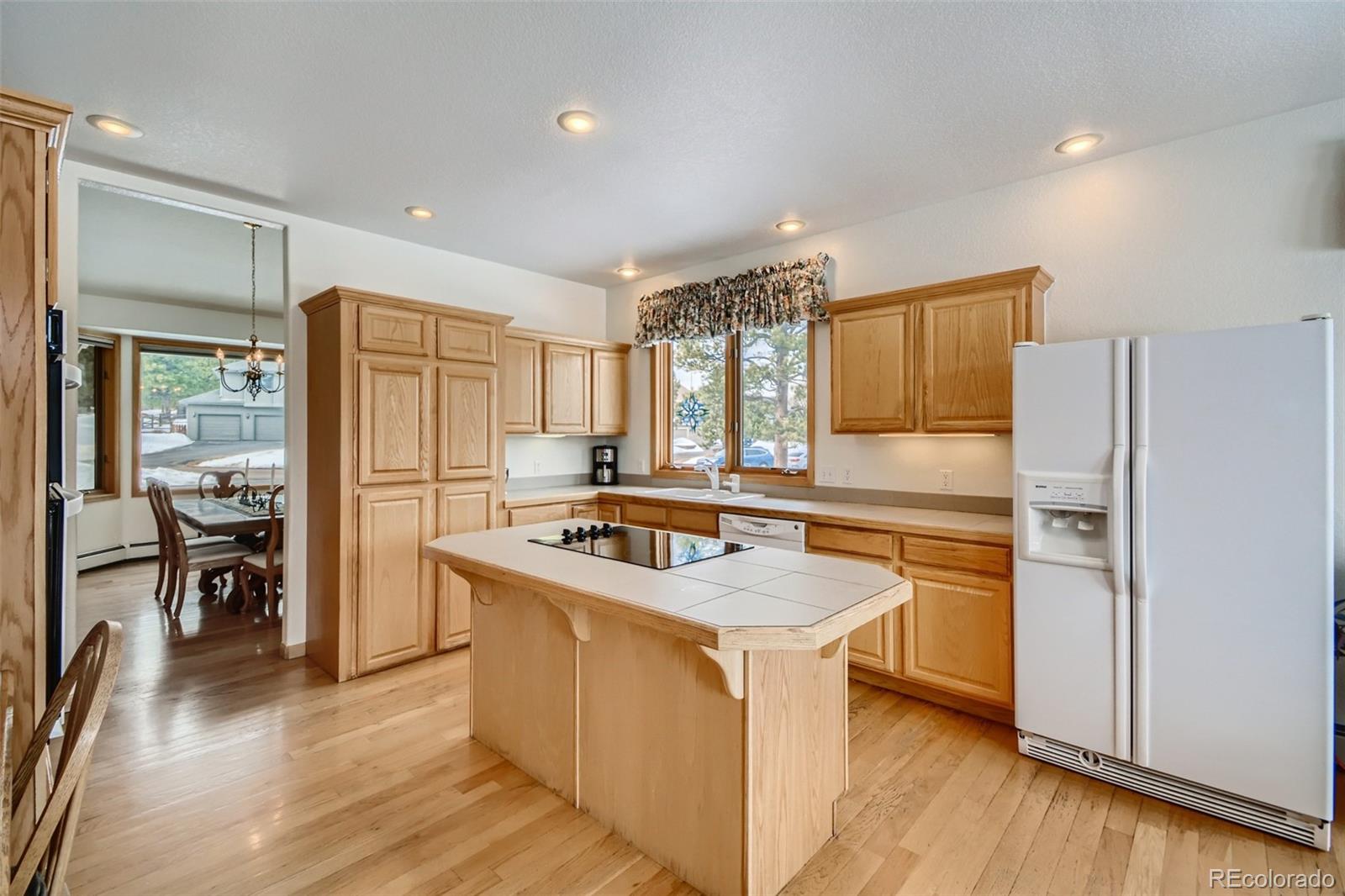 1634 Muirfield Lane Evergreen, CO 80439 - Photo 13 of 40 a kitchen with stainless steel appliances granite countertop a refrigerator and a stove top oven
