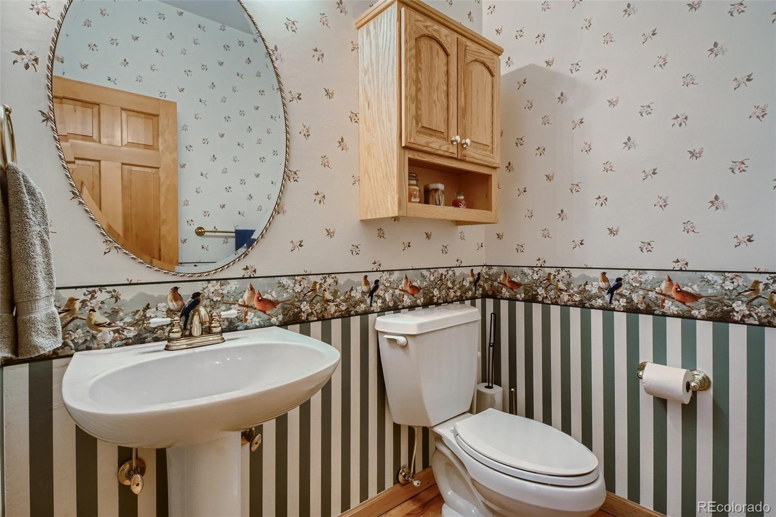 1634 Muirfield Lane Evergreen, CO 80439 - Photo 20 of 40 a bathroom with a toilet a sink and a mirror