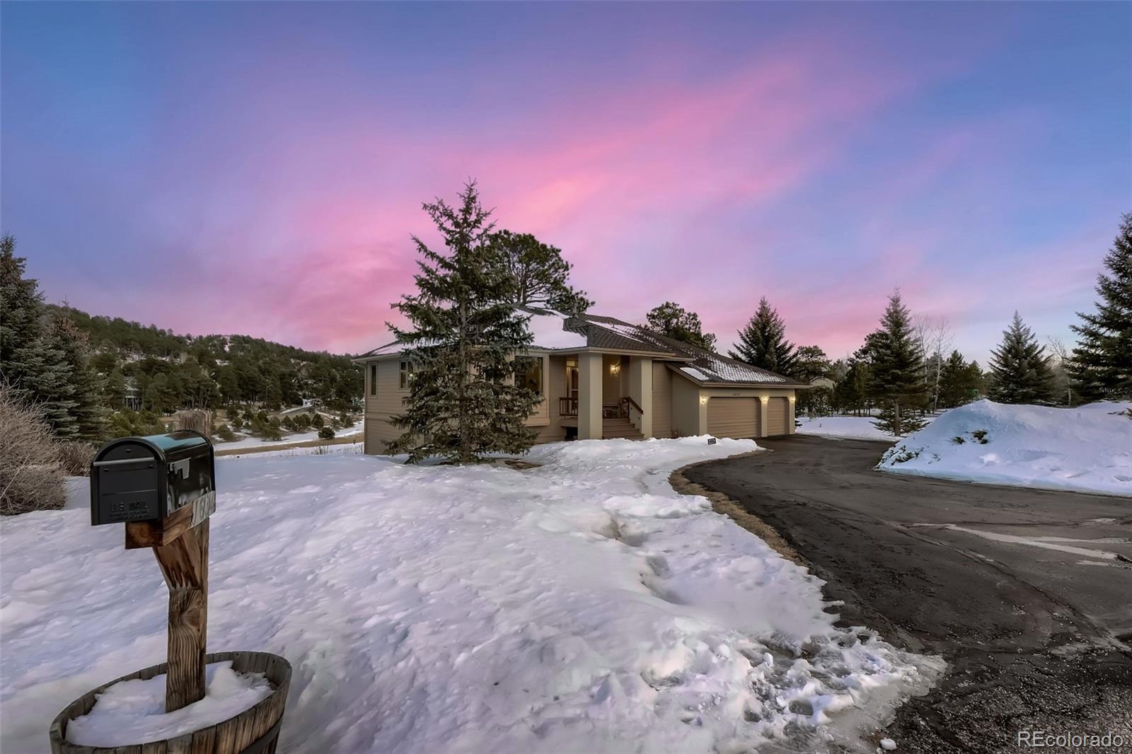 1634 Muirfield Lane Evergreen, CO 80439 - Photo 2 of 40 a front view of a house with a yard