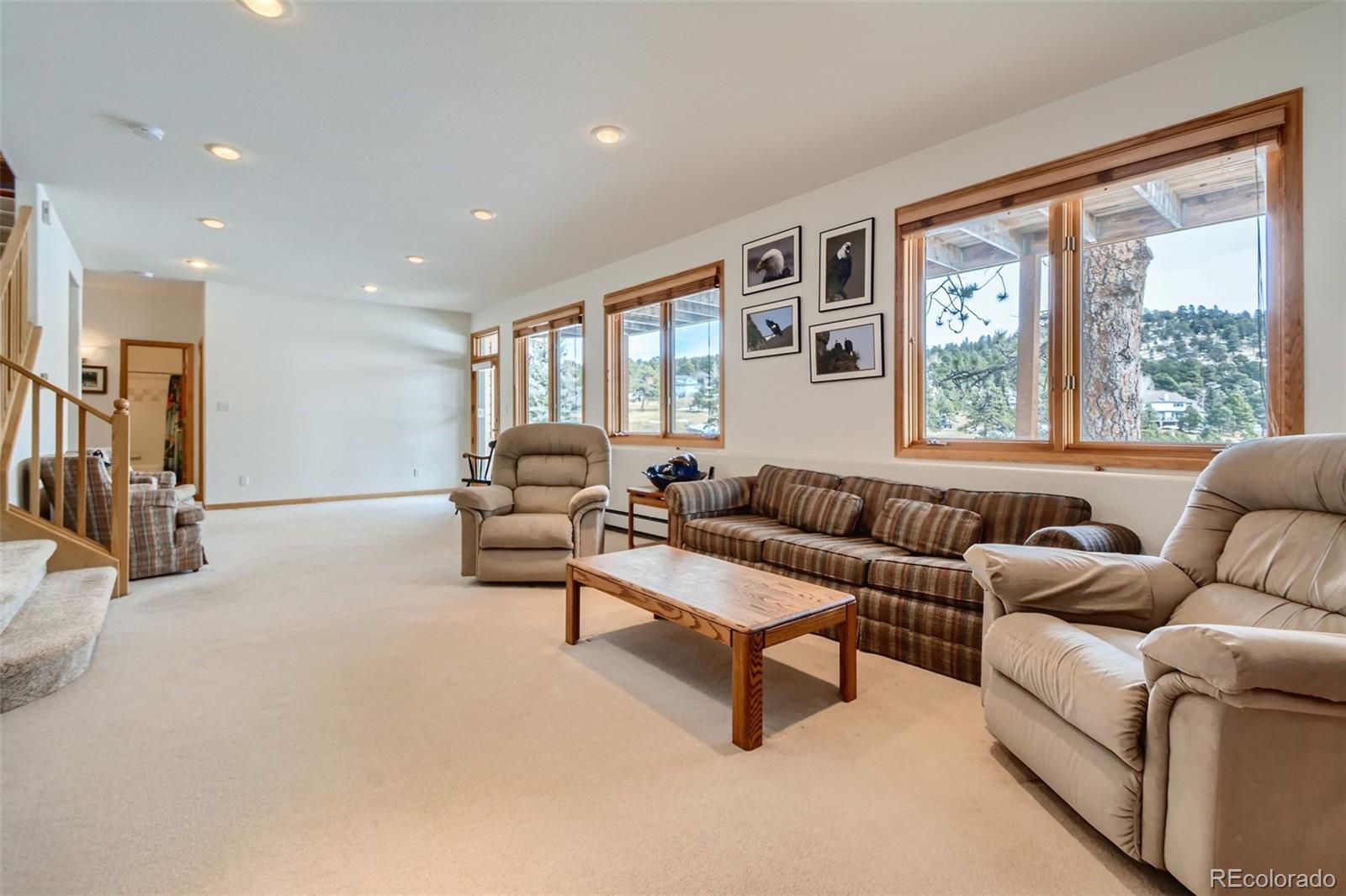 1634 Muirfield Lane Evergreen, CO 80439 - Photo 22 of 40 a living room with furniture and large windows