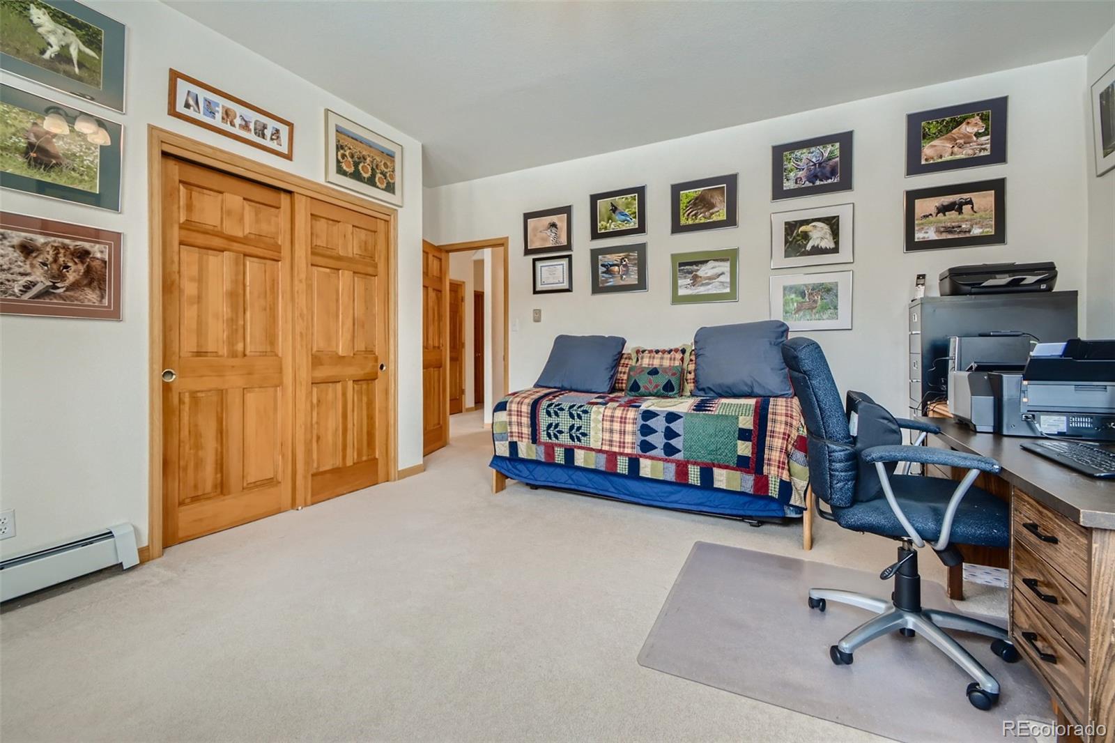 1634 Muirfield Lane Evergreen, CO 80439 - Photo 27 of 40 a bedroom with furniture and a window