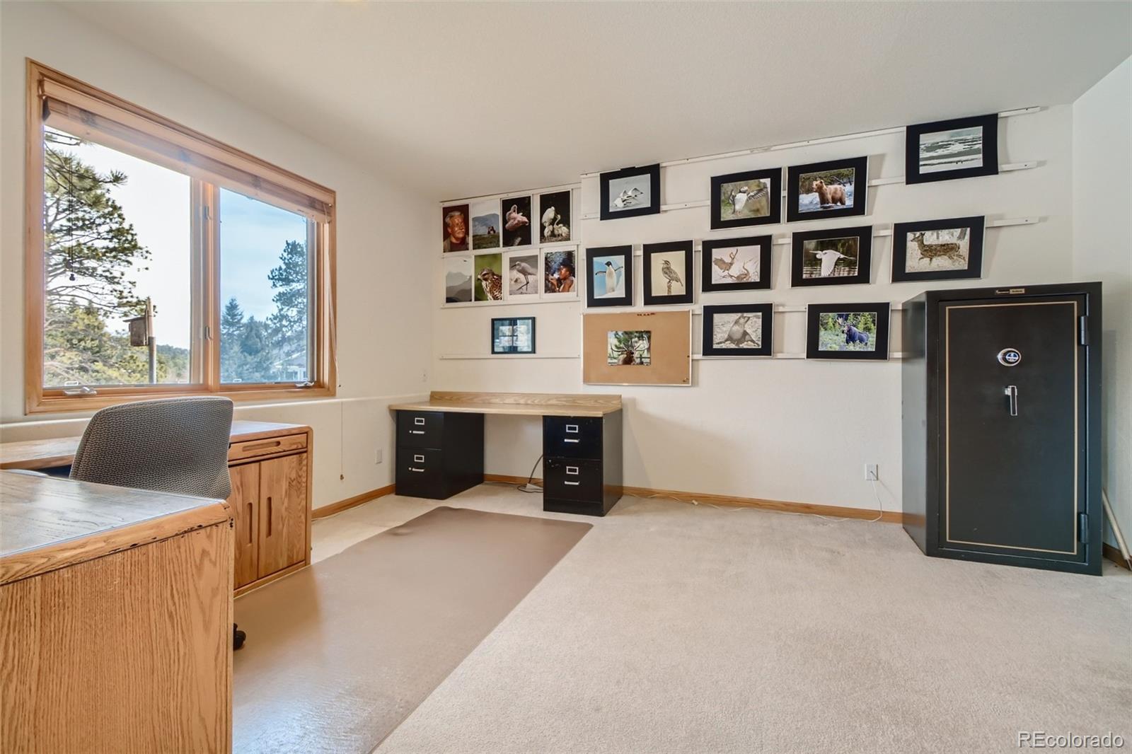 1634 Muirfield Lane Evergreen, CO 80439 - Photo 29 of 40 a view of a bedroom with furniture and window