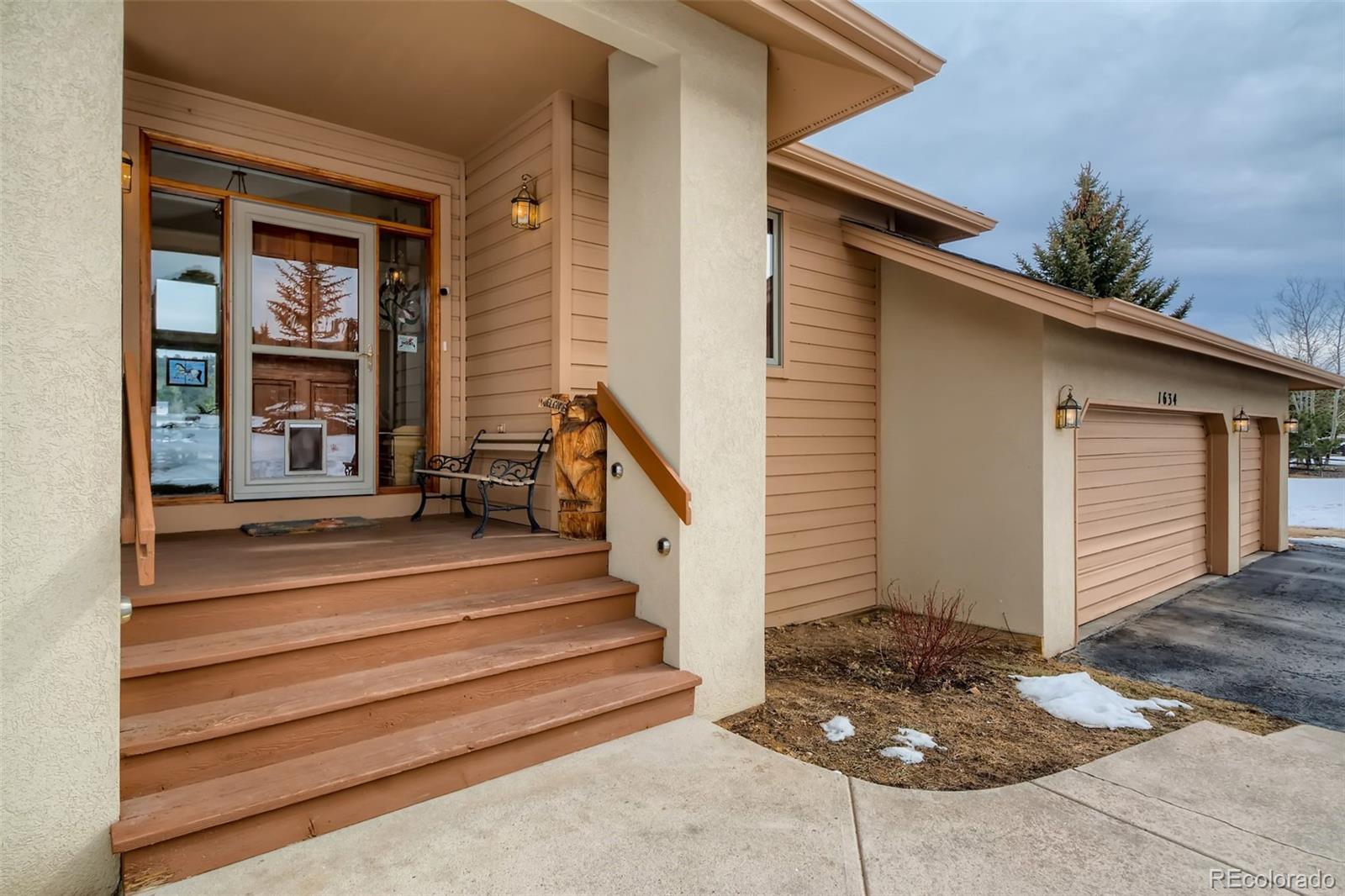 1634 Muirfield Lane Evergreen, CO 80439 - Photo 3 of 40 a front view of a house with entryway