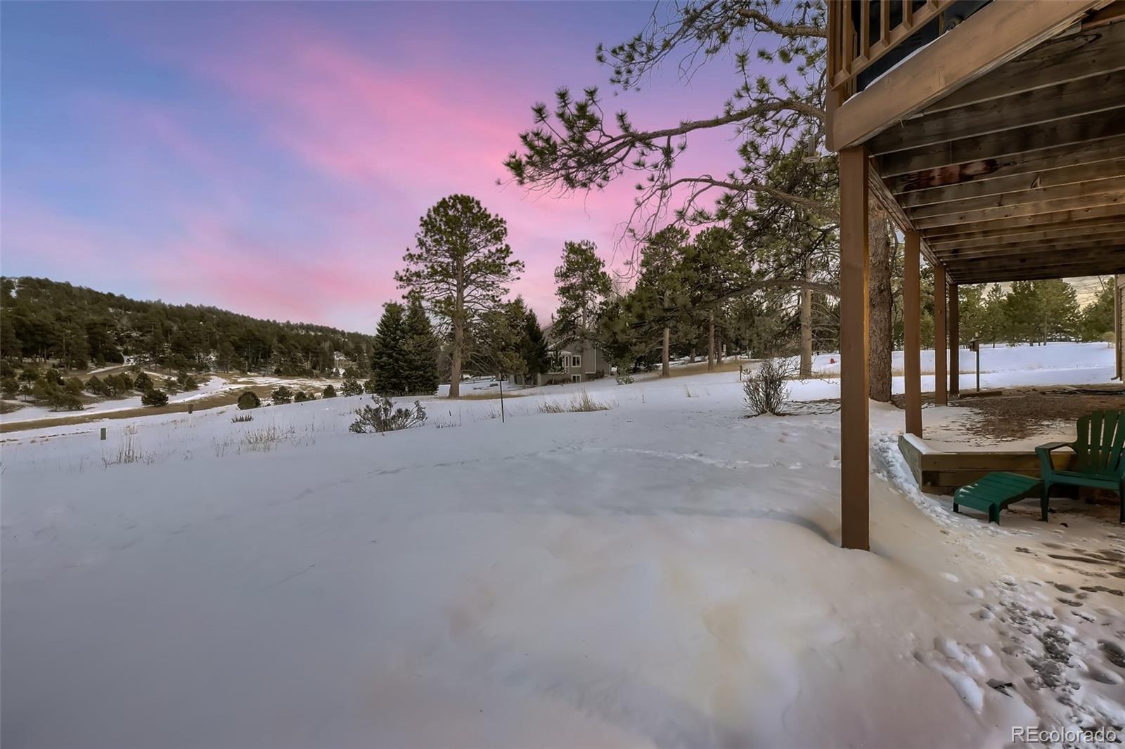1634 Muirfield Lane Evergreen, CO 80439 - Photo 37 of 40 a view of a road with a bench in front of it