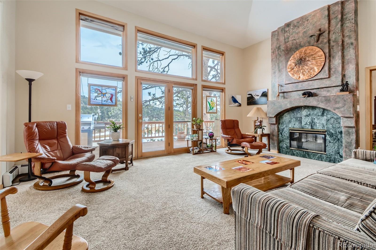 1634 Muirfield Lane Evergreen, CO 80439 - Photo 6 of 40 a living room with furniture a fireplace and a large window