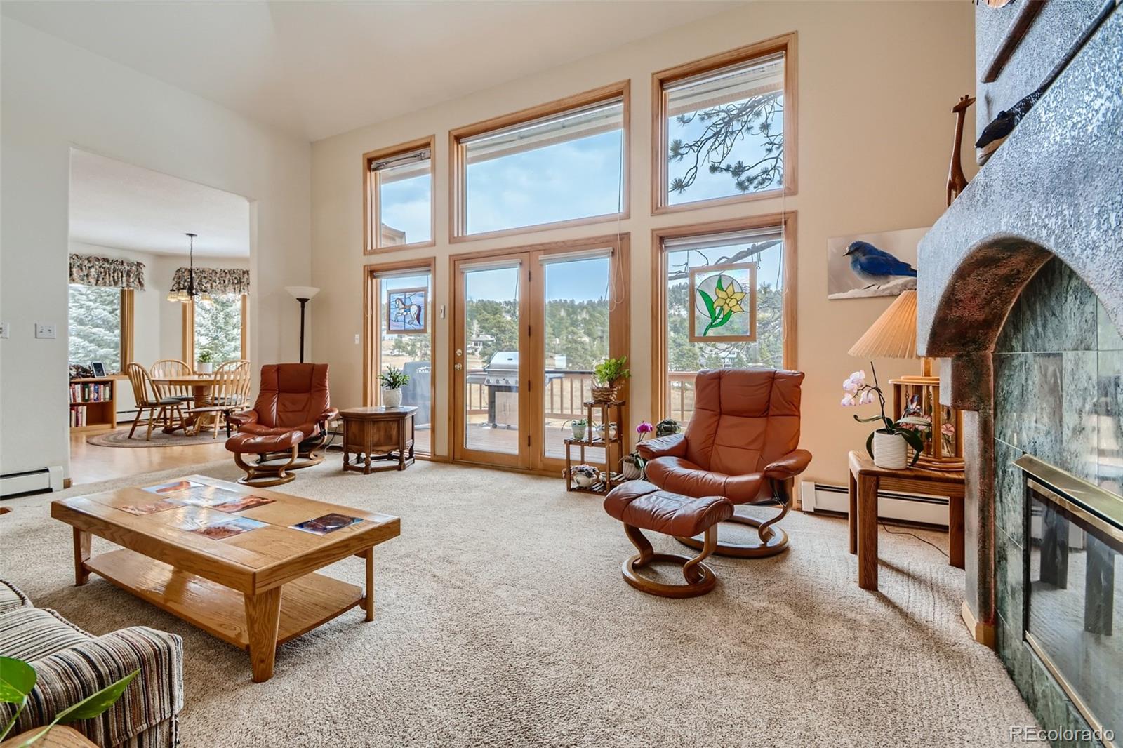 1634 Muirfield Lane Evergreen, CO 80439 - Photo 7 of 40 a living room with furniture and a floor to ceiling window