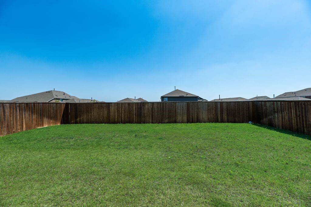 14216 Aberavon Drive Pilot Point, TX 76258 - Photo 18 of 19 Expansive green lawn with a perimeter wood privacy fence