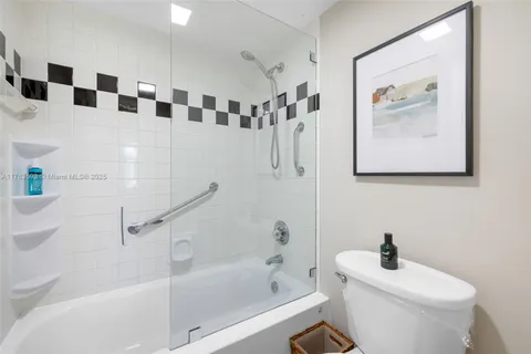 a bathroom with a bathtub sink vanity and toilet
