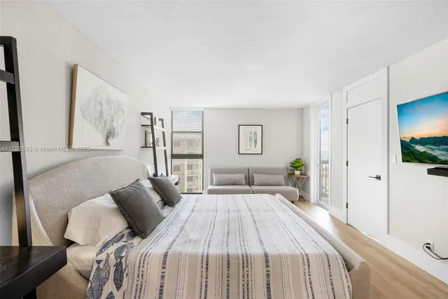 a bedroom with a large bed and a window